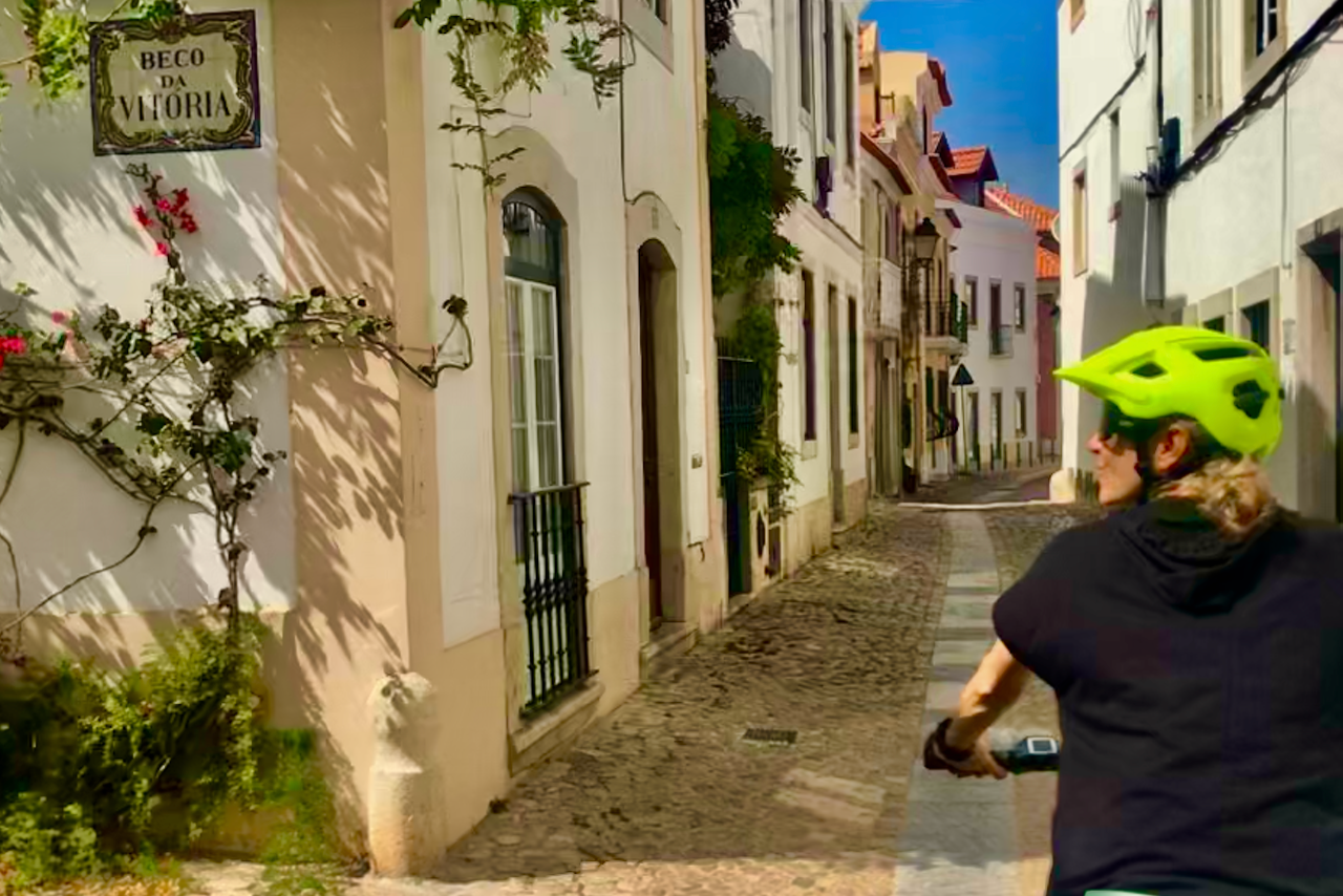 Cyclists exploring Cascais landmarks along the coast — Santa Marta lighthouse, Guincho beach and old town