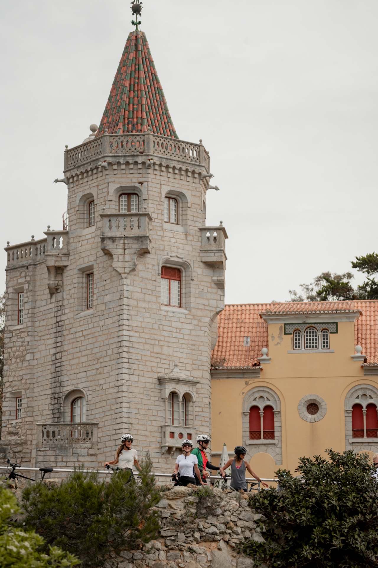 Cyclists exploring Cascais landmarks along the coast — Santa Marta lighthouse, Guincho beach and old town