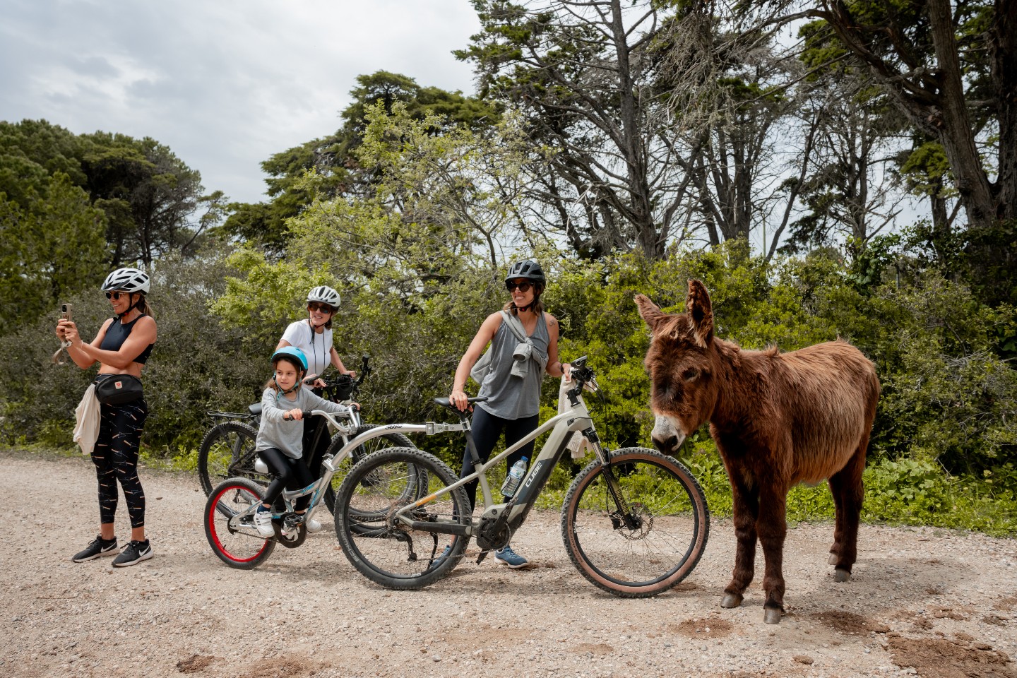 Riders pausing on a clifftop with bikes overlooking the Atlantic near Cascais