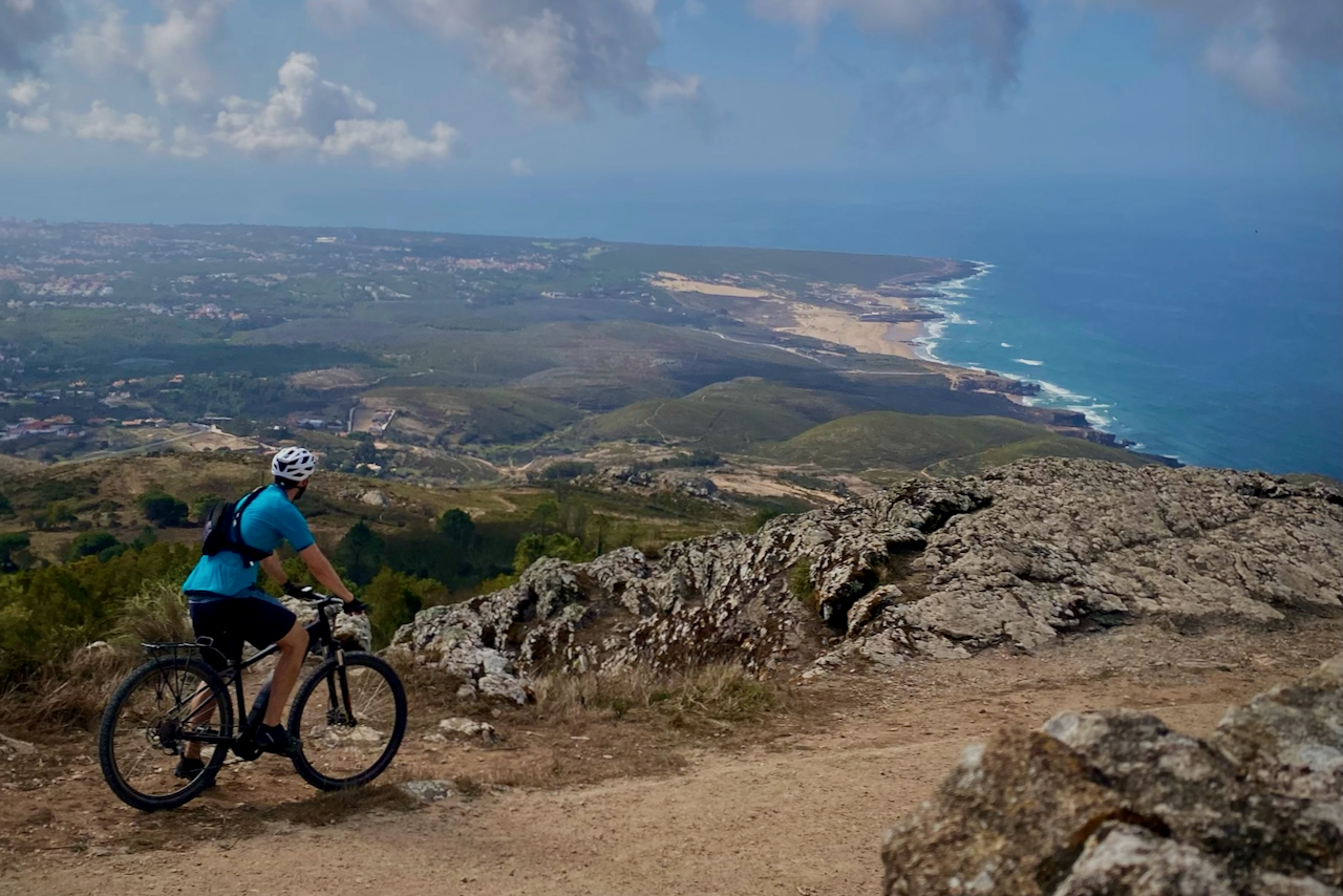 Rider on a Sintra-Cascais hilltop trail overlooking the Atlantic coast